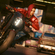 V rides a motorcycle down a busy street in Cyberpunk 2077 on PS4 to PS5.